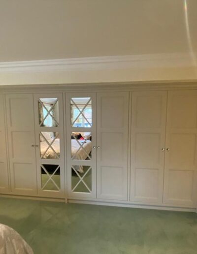 4.5 metre shaker style wardrobe, oak interiors, center fret mirrored doors finished in Farrow & Ball drop cloth paint