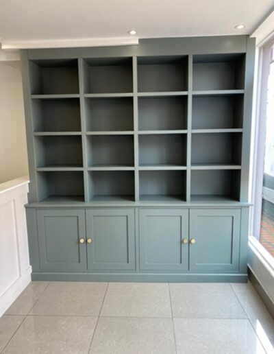 Bespoke shaker style display unit for The Strand Chelmsford. Fitted with brass knobs & finished in Farrow & Ball green smoke paint