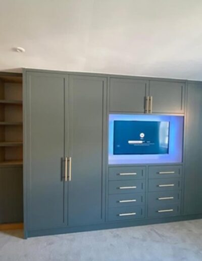 Wardrobe unit with recessed TV, remote sensor light strip & solid brass handles