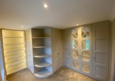 Walk-in wardrobe with shoe display unit & open glass display section