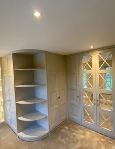 Shaker style walk-in wardrobe with shoe display & featured LED strip lights