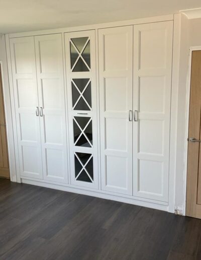 Wardrobe with fret grey smoked mirrored door, oak interiors & an internal chest of drawers, crystal handles, finished in Farrow & Ball wevet paint