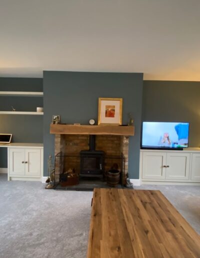 Two shaker style alcove units & floating shelves with a desk one side & media cabinet on the other finished in farm house white