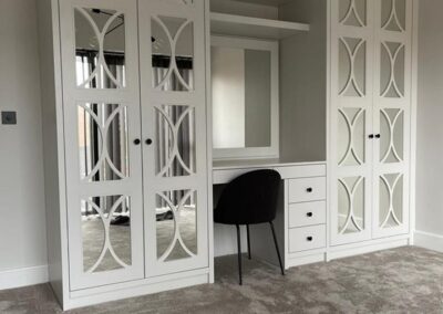 bespoke fret design dressing room wardrobe with dressing table, drawers, shelves for handbags & space for a mirror