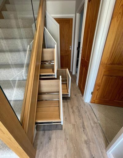 Understairs shaker style storage system 3 shoe storage drawers, 2 coat cupboards.