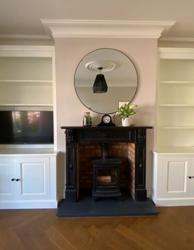 Alcove units one with space for a TV, detailed shaker doors with feature cornice, finished in Farrow and Ball Wimborne white