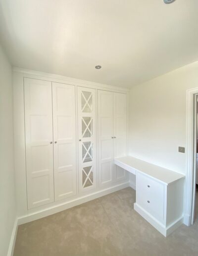 Dressing room install shaker style panelled wardrobes with fret mirrored centre doors, all units have oak Interiors finished in Symphony Coating Co brilliant white paint
