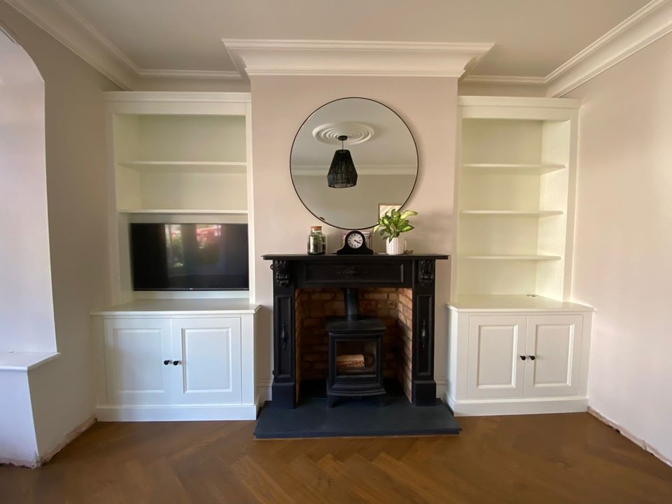 Alcove units one with space for a TV, detailed shaker doors with feature cornice, finished in Farrow and Ball Wimborne white