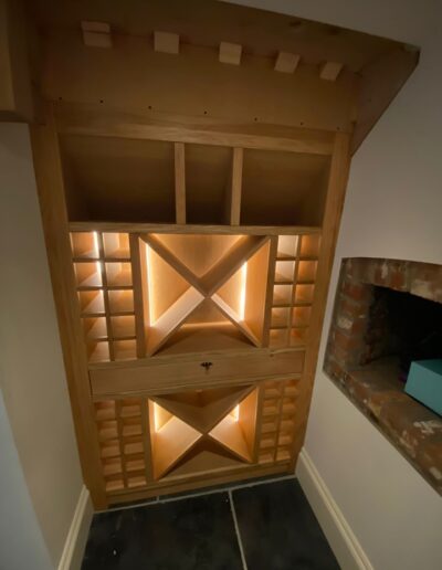 Bespoke oak wine rack with recessed LED strip lights & lined wine drawer