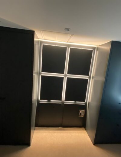 a modern design wardrobe with oak interiors & panelled headboard with LED remote strips lights finished in Farrow & Ball railings paint.