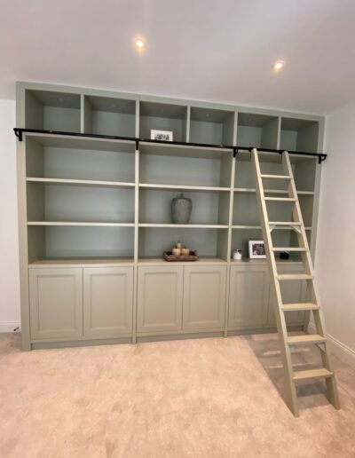 Bespoke book case with ladder, LED remote lights, push touch shaker style doors, finished in Farrow & Ball School house white