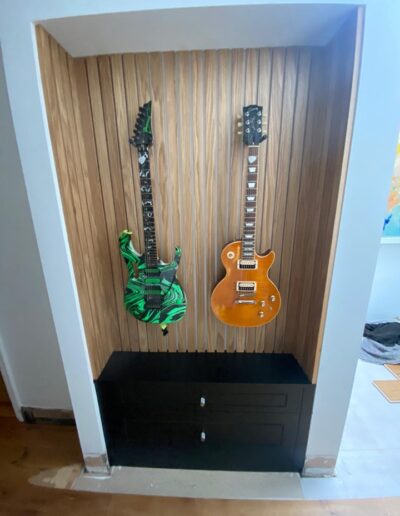 Bespoke alcove unit with feature hanging guitars