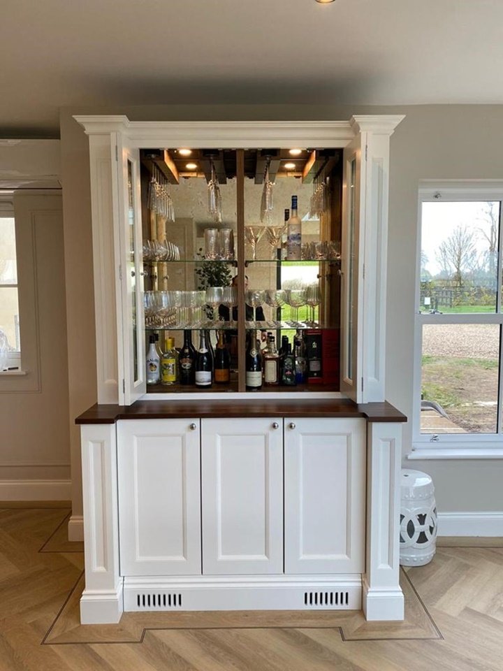 Bespoke bar unit with bronze back mirrors, integrated lights and internal wine coolers