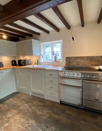 Bespoke kitchen finished in Farrow and Ball paint with solid oak worktops, integrated appliances, plinth heater and LED down lights.