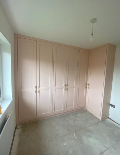 Unique shaker style fitted wardrobe with corner unit, oak internals, hanging & shelve storage, finished in Farrow and Ball pink ground paint