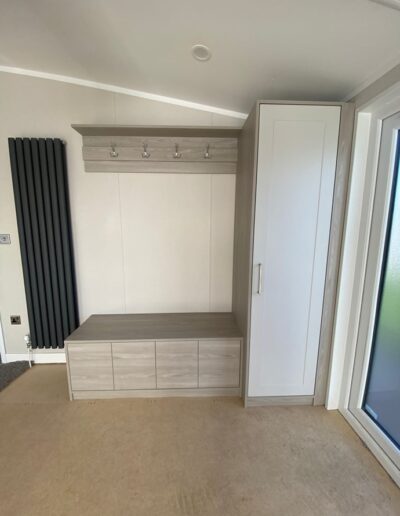 Custom-made bench storage unit for a new lodge, made from Xylocleaf board with a painted door and LED lights on a remote switch