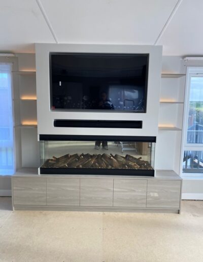 Bespoke media wall made from Xylocleaf board with a feature glass fire finished in Farrow and Ball ceviche paint