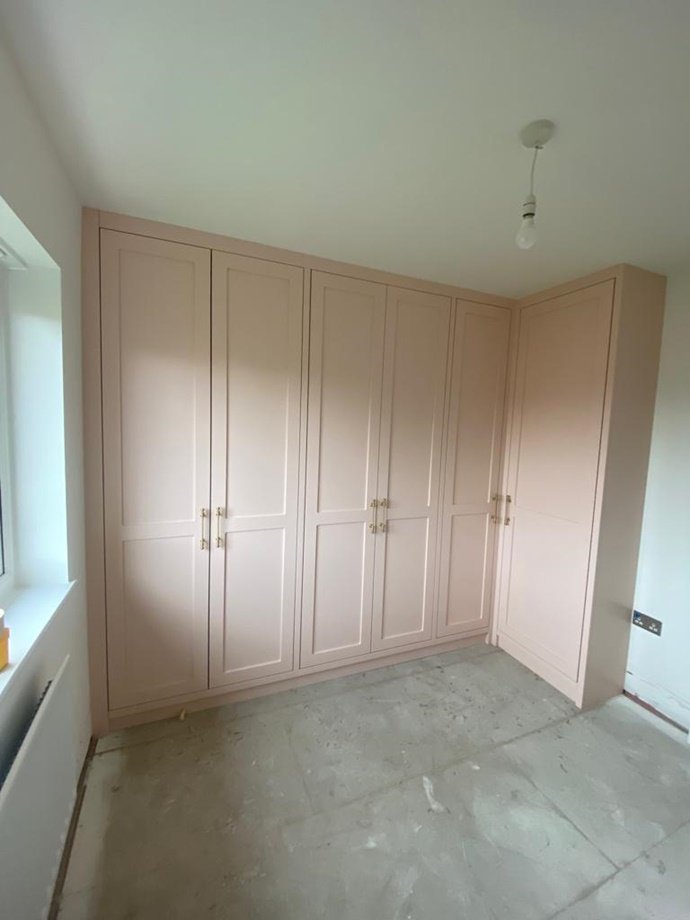 Unique shaker style fitted wardrobe with corner unit, oak internals, hanging & shelve storage, finished in Farrow and Ball pink ground paint