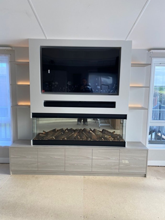 Bespoke media wall made from Xylocleaf board with a feature glass fire finished in Farrow and Ball ceviche paint