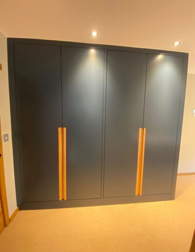 Fitted wardrobe with a glass fronted internal chest, internal mirror, soft close openings, solid oak recessed handles