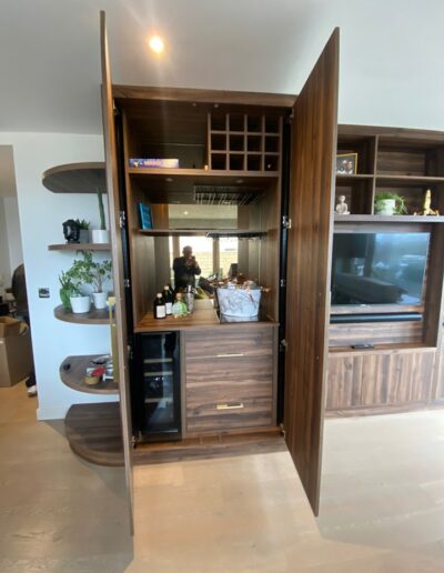 Walnut bar and media unit with integrated wine fridge and housing for TV