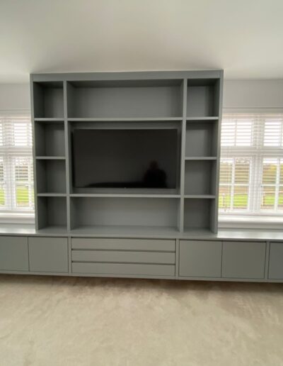 Bespoke floating media wall, 5.2m wide oak internals, handleless soft close doors and drawers finished in Farrow and Ball manor house grey paint