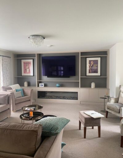 Custom-made 4.6m long media wall made in Xylocleaf sheets with a 75 inch TV, integrated fireplace, recessed LED remote lighting, push touch doors