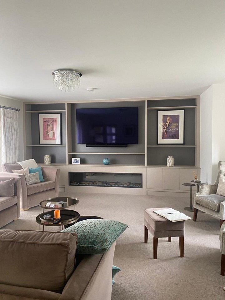 Custom-made 4.6m long media wall made in Xylocleaf sheets with a 75 inch TV, integrated fireplace, recessed LED remote lighting, push touch doors