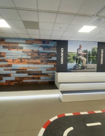 Shop display platforms for mobility & wheelchair made from XyloCleaf high gloss and sheet matt boards and recessed strip lights.