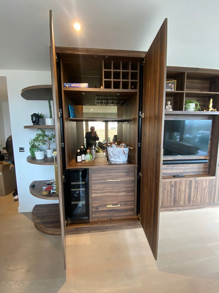 Walnut bar and media unit with integrated wine fridge and housing for TV