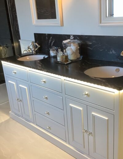 Bespoke vanity unit with Finsauk oak internals, soft close openings, painted finish to coordinate with their bathroom, client sourced stone top.