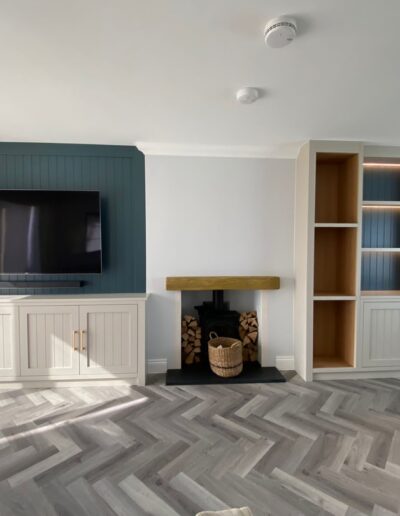 Bespoke alcove units with FinsaUK oak internals, remote LED strip lights, finished in Lick paint beige 04 & grey 08. One unit with log storage and one incorporated a TV