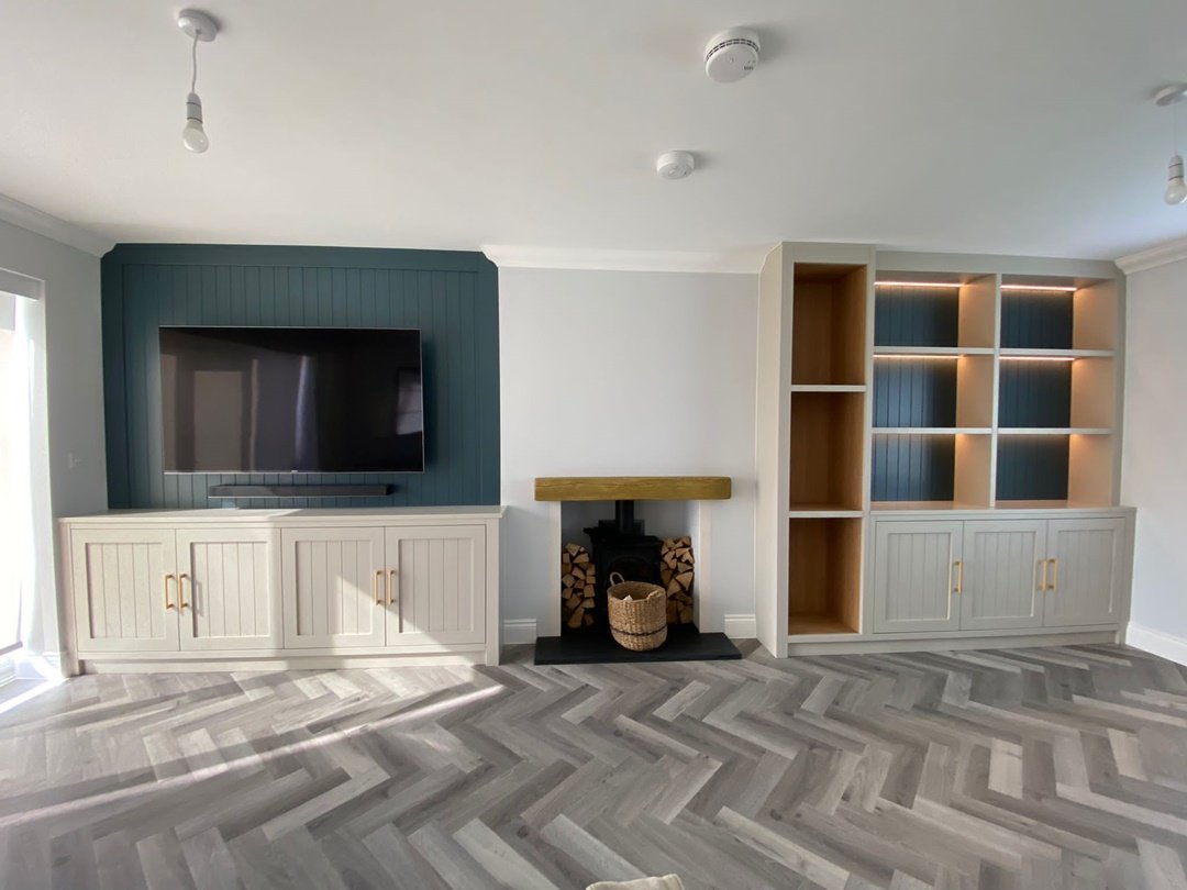 Bespoke alcove units with FinsaUK oak internals, remote LED strip lights, finished in Lick paint beige 04 & grey 08. One unit with log storage and one incorporated a TV