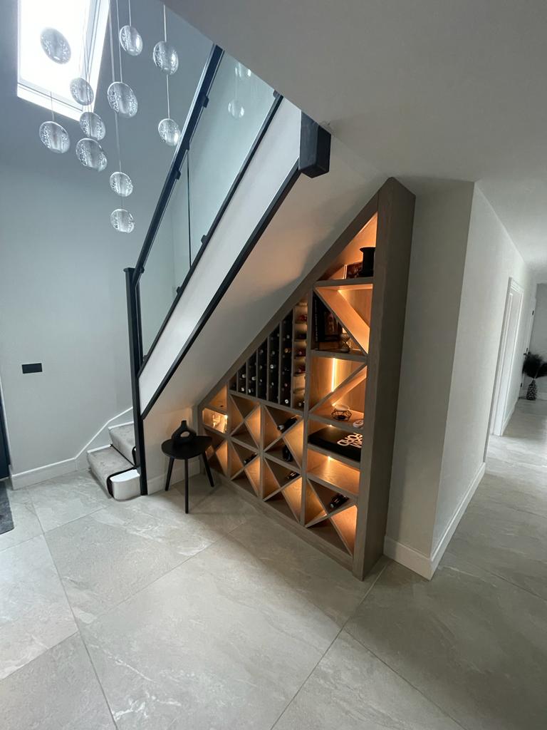 Bespoke under stairs wine storage rack with internal lights, finished in a grey oil