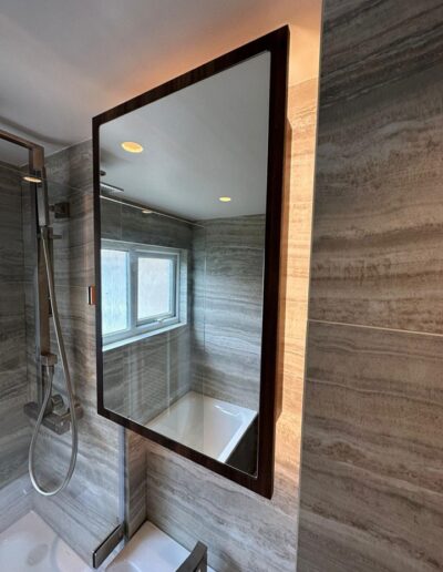 Bespoke bathroom mirrored storage cupboard with featured LED backlights & internal shelve storage made in Finsa UK Nogul Valentina