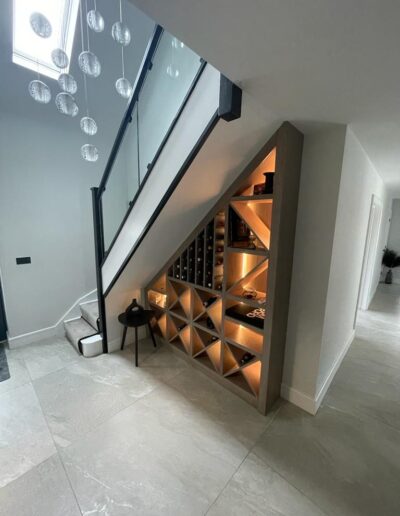 Bespoke under stairs wine storage rack with internal lights, finished in a grey oil