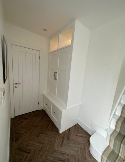 Made-to-measure shaker style coat storage unit with LED remote lights, finished in brilliant white paint