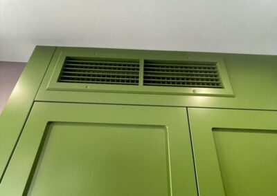 Wardrobe enclosing air con unit