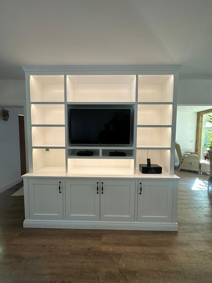 Custom-made shaker style media wall oak internals on the lower storage cupboards with soft close doors remote controlled lights finished in ice white paint