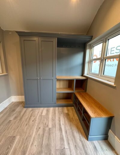 Shaker style fitted boot room unit with oak internals and bench top providing ample space for coats and shoes, finished in French mid-tone blue “BTWN dog & wolf” by Paint and Paper Librar