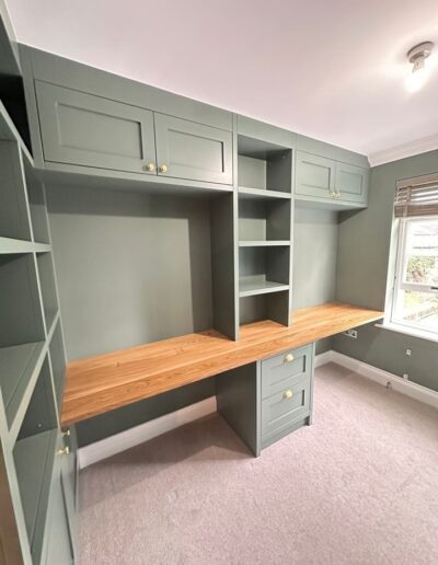 Custom-made shaker-style home office unit with large workspace, ample storage and discreet power sockets finished in Farrow and Ball green smoke