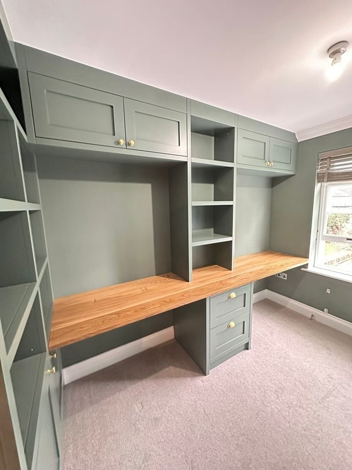 Custom-made shaker-style home office unit with large workspace, ample storage and discreet power sockets finished in Farrow and Ball green smoke