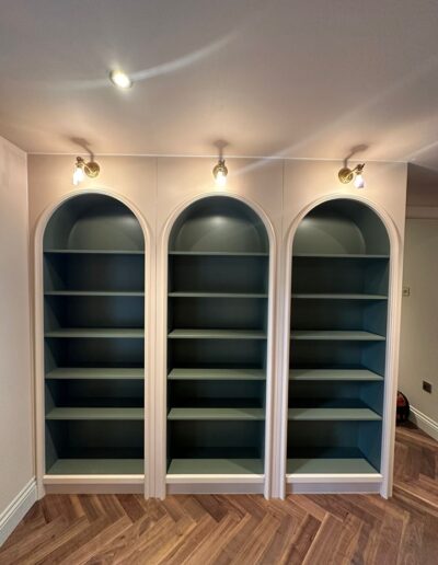 Custom made curved bookcases with molded arches, Atelier Ellis Totara finish, exterior coated in Farrow and Ball Setting Plaster Paint