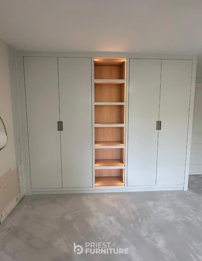 Bespoke fitted wardrobes with stained grey oak veneer internals and finished in Strong White by Farrow & Ball.
